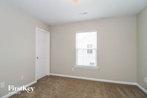Clemmons house for rent - a bedroom with carpet and a door and a window
