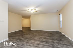 Indianapolis house for rent - A spacious room with a ceiling fan and light fixture.