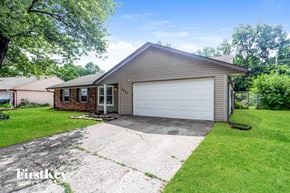 Indianapolis house for rent - A house with a garage and a driveway in front of it.
