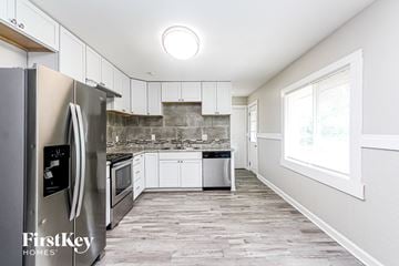 Indianapolis house for rent - A kitchen with a refrigerator, microwave, and oven.