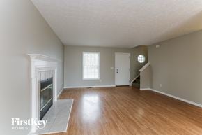 Galloway house for rent - an empty living room with a fireplace and wooden floors
