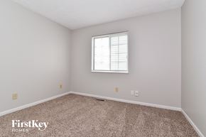 Indianapolis house for rent - a bedroom with carpet and a window