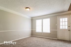 Memphis house for rent - the dining room of an empty house with a door and window