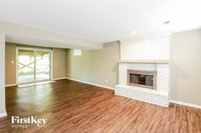 Parkville house for rent - a living room with a fireplace and a wooden floor