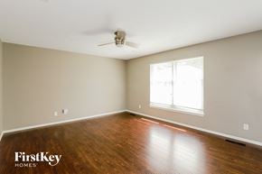 Parkville house for rent - a bedroom with wood floors and a ceiling fan