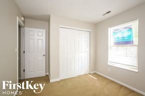 Indianapolis house for rent - a bedroom with two white doors and a window