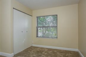 Lake Worth house for rent - an empty bedroom with a window and a closet