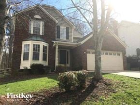 Charlotte house for rent - a brick house with a white garage door