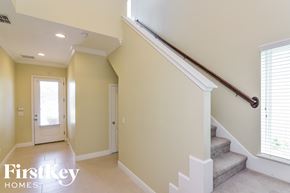 Lithia house for rent - A staircase with a wooden handrail leads up to a window.