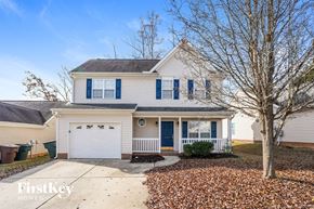 Greensboro house for rent - A house with a blue garage door is for sale.