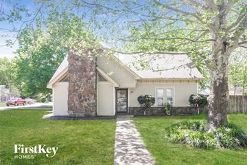Memphis house for rent - a white house with a sidewalk in front of a lawn and trees