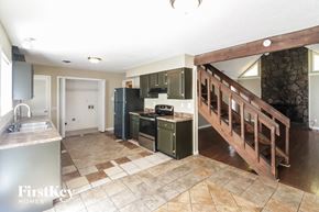 Memphis house for rent - a kitchen with a staircase and a stove and a refrigerator