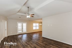 Arlington house for rent - the living room of an empty house with a ceiling fan