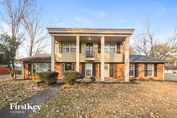 Memphis house for rent - the front of a two story house with columns and a yard