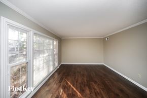 Memphis house for rent - an empty living room with wood floors and a large window