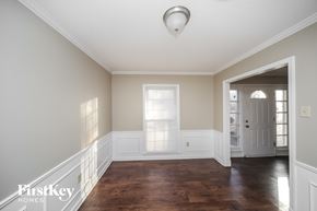 Memphis house for rent - a hallway with wood floors and a white door