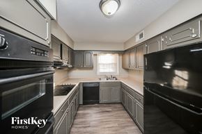 Memphis house for rent - a kitchen with black appliances and white cabinets