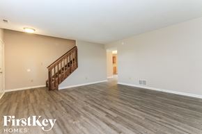 Indianapolis house for rent - the living room and dining room with wood floors and white walls