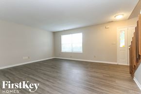 Indianapolis house for rent - an empty living room with wood floors and a window