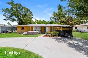 Bradenton house for rent - A house with a yellow front and a white background with the words "FirstKey Homes" on it.