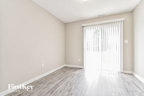 Indianapolis house for rent - a spacious living room with wood floors and a sliding glass door