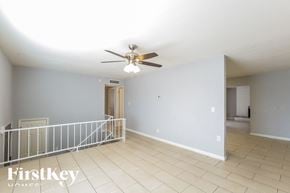 Phoenix house for rent - A spacious room with a fan and a balcony.