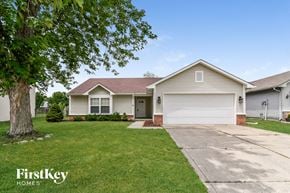 Indianapolis house for rent - a white house with a driveway and a tree