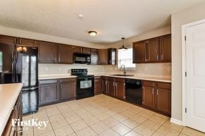 Indianapolis house for rent - a kitchen with wooden cabinets and black appliances