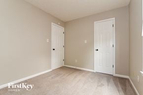 Indianapolis house for rent - a bedroom with two doors and a carpeted floor