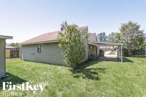 Memphis house for rent - the backyard of a house with a yard and a gazebo