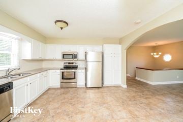 Clemmons house for rent - A kitchen with white cabinets and a tiled floor.