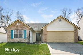 Indianapolis house for rent - A house with a garage and a driveway in front of it.