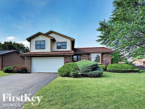 Matteson house for rent - a house with a garage and a lawn