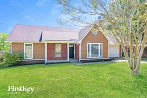 Olive Branch house for rent - A house with a red roof and a tree in front.