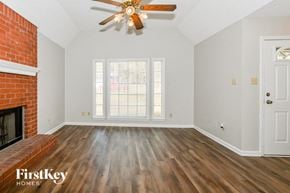 Olive Branch house for rent - A room with a wooden floor and a ceiling fan.