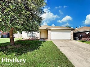 Fort Worth house for rent - the front of a house with a driveway and a tree