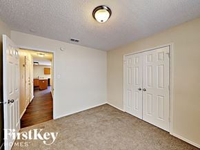Fort Worth house for rent - a bedroom with two closets and a door to a hallway