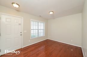 High Point house for rent - A room with a wooden floor and a white door.