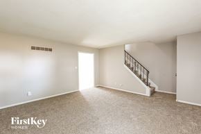 Grandview house for rent - A spacious empty room with a staircase leading to the second floor.