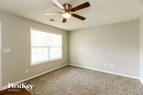 Covington house for rent - A room with a ceiling fan and a window.