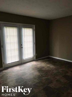 Indianapolis house for rent - A room with a sliding door and a tiled floor.