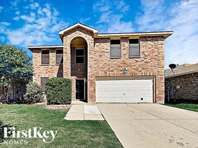 Denton house for rent - a brick house with a white garage door
