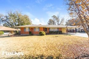 Bartlett house for rent - a small brick house with a yard and trees