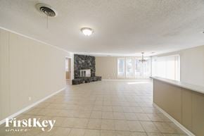 Bartlett house for rent - a large living room with a tile floor and a fireplace