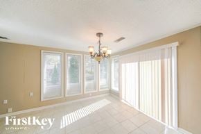 Bartlett house for rent - a dining room with large windows and a chandelier