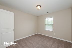 Rex house for rent - the bedroom of a home with carpet and a window