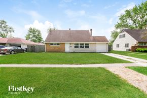 Indianapolis house for rent - A house with a brown roof and a white garage door is for sale.