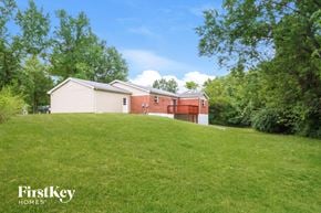 Florissant house for rent - a house on a hill with a grassy yard