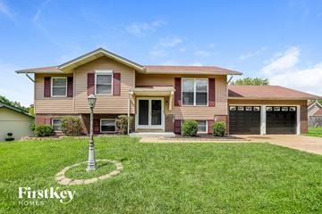 Florissant house for rent - a house with a lawn and a street light in front of it