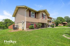 Florissant house for rent - a home with a lawn and a fence in front of it